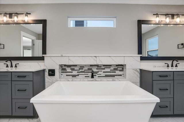 bathroom featuring vanity and a bath