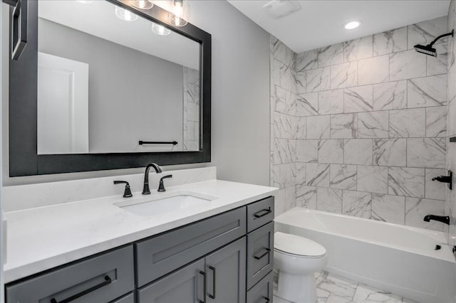 full bathroom featuring tiled shower / bath combo, toilet, and vanity