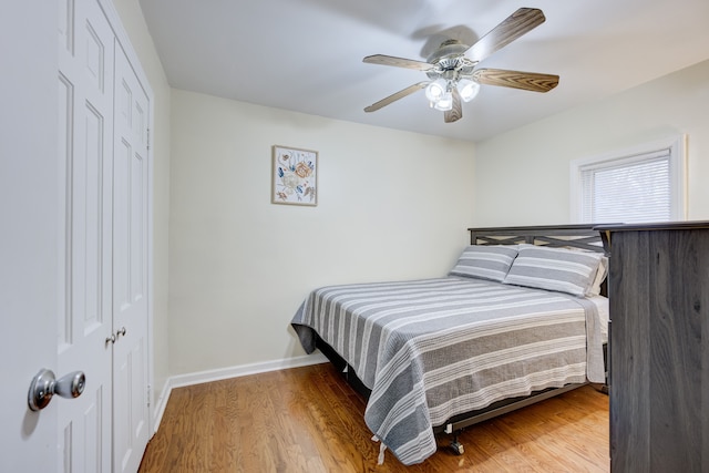 bedroom featuring ceiling fan, a closet, and wood-type flooring