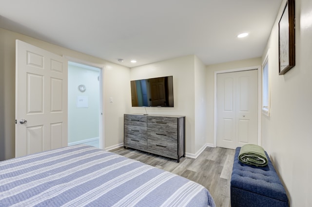 bedroom with a closet and light hardwood / wood-style flooring