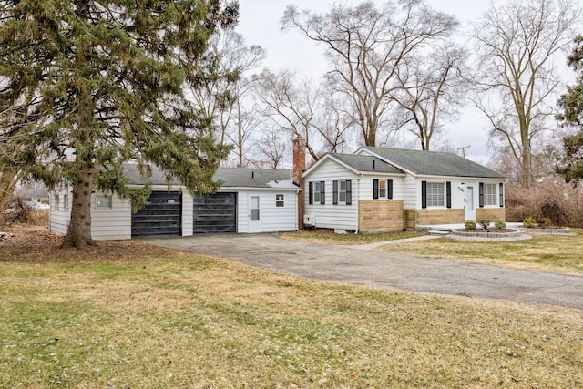 view of front facade with a front yard and a garage