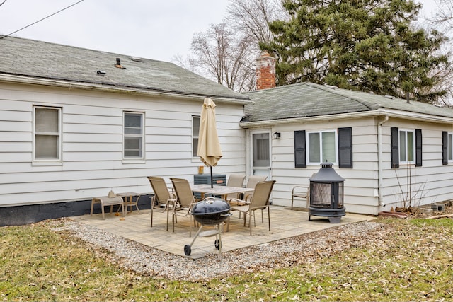 back of house featuring a patio area and an outdoor fire pit