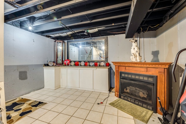 basement with light tile patterned flooring