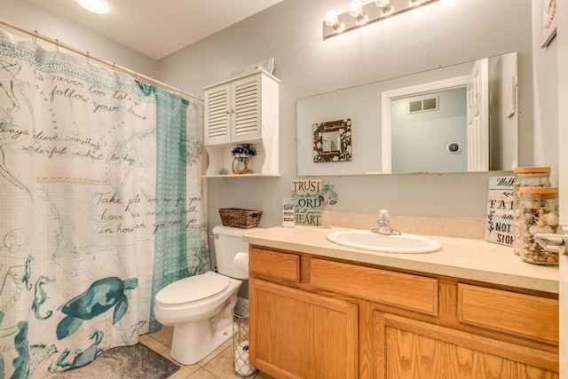 bathroom featuring toilet, vanity, tile patterned floors, and walk in shower