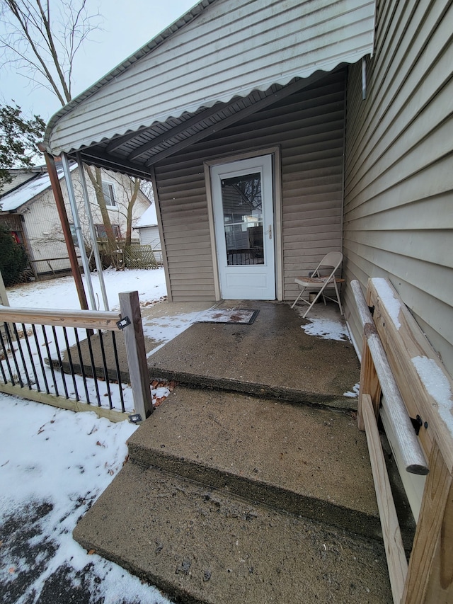 view of snow covered property entrance