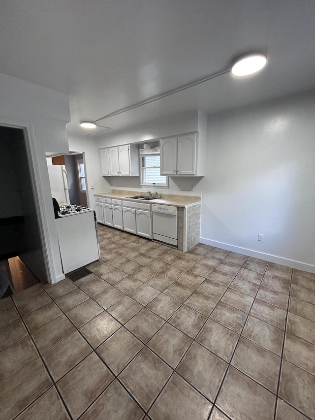 kitchen featuring white cabinetry, sink, white appliances, and tile patterned flooring