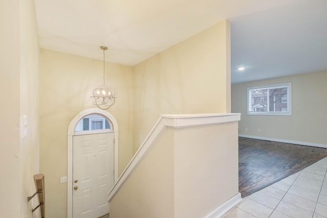 entrance foyer with light tile patterned flooring and a chandelier