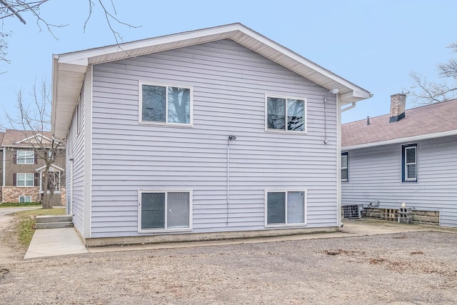 rear view of house featuring central air condition unit