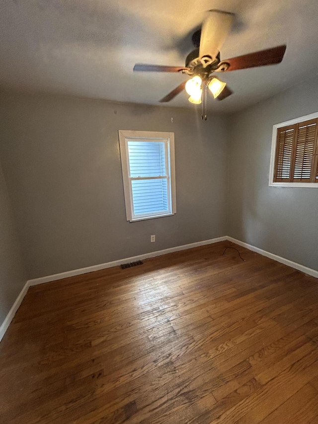 spare room with ceiling fan and dark hardwood / wood-style flooring