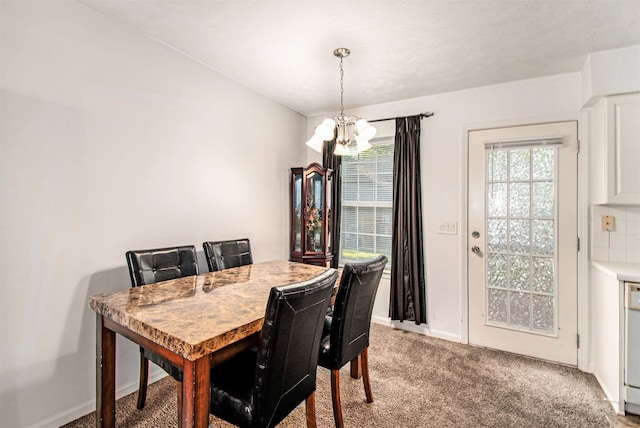 dining area with a chandelier and light carpet