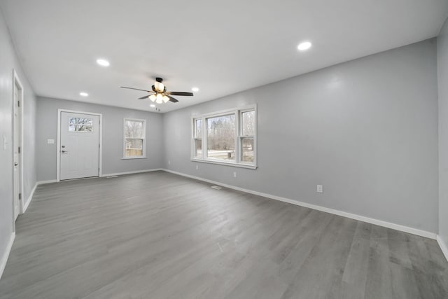 spare room featuring light wood-type flooring and ceiling fan