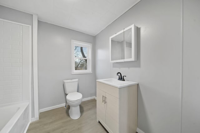 bathroom with hardwood / wood-style floors, vanity, and toilet