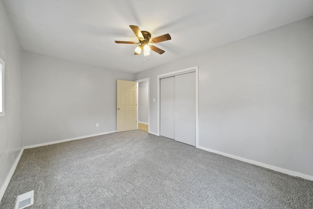 unfurnished bedroom featuring carpet flooring, ceiling fan, and a closet