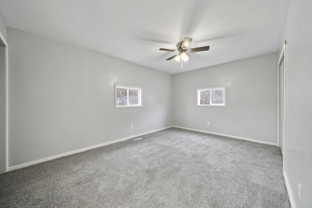 spare room featuring carpet flooring and ceiling fan