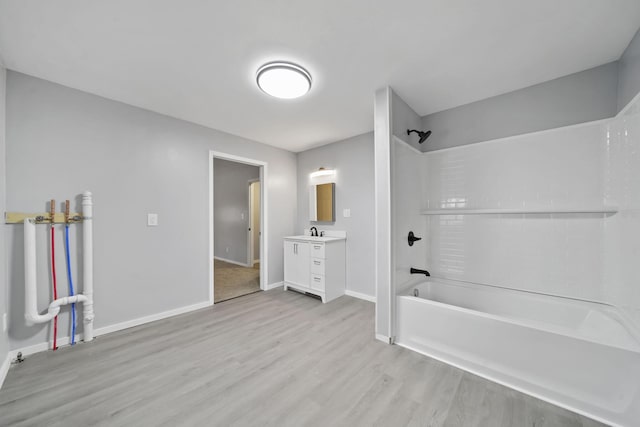 bathroom with shower / tub combination, vanity, and hardwood / wood-style flooring