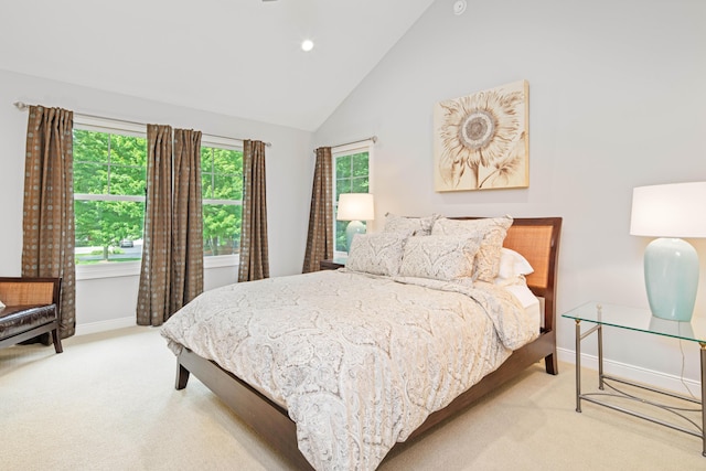 bedroom with light carpet and high vaulted ceiling