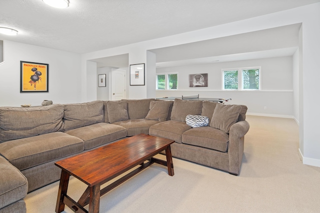 living room featuring light colored carpet and a textured ceiling