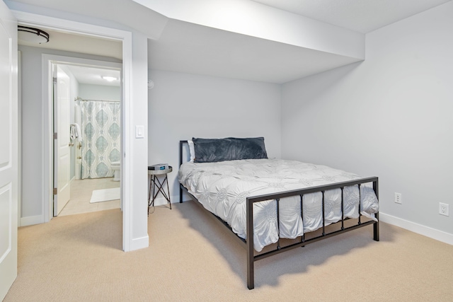 carpeted bedroom featuring ensuite bathroom