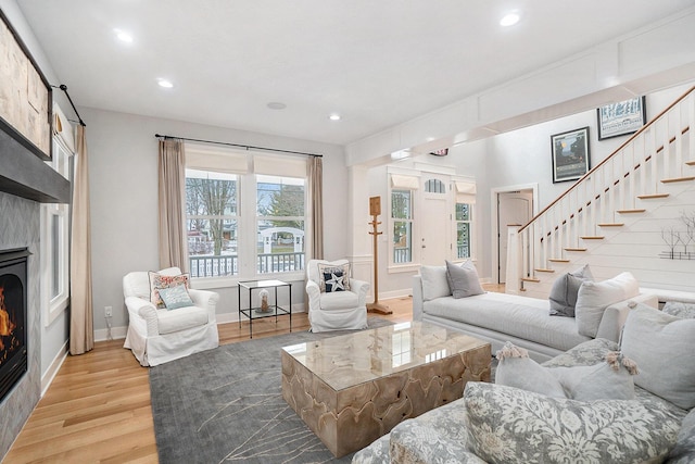 living room with a fireplace and light hardwood / wood-style flooring