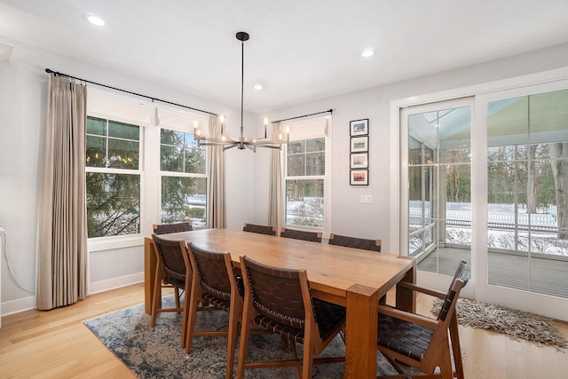 dining room with a notable chandelier and light hardwood / wood-style flooring