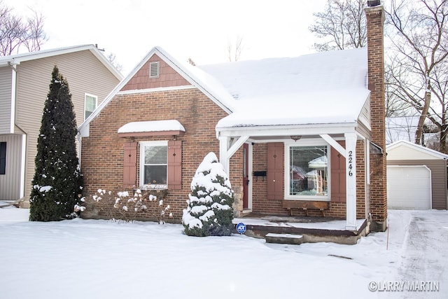 view of front of property with a garage and an outdoor structure