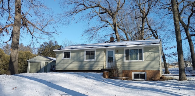 ranch-style home featuring a storage shed