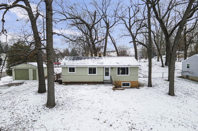 view of front of property featuring a garage and an outdoor structure