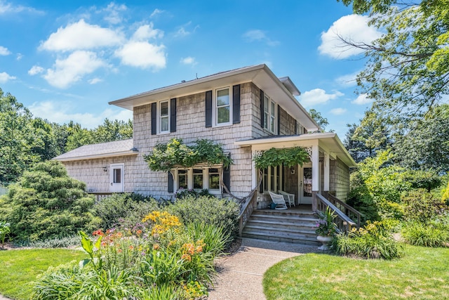 view of front of property with a porch and a front yard