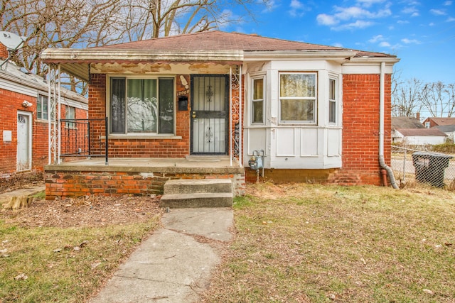 bungalow-style house with covered porch and a front yard