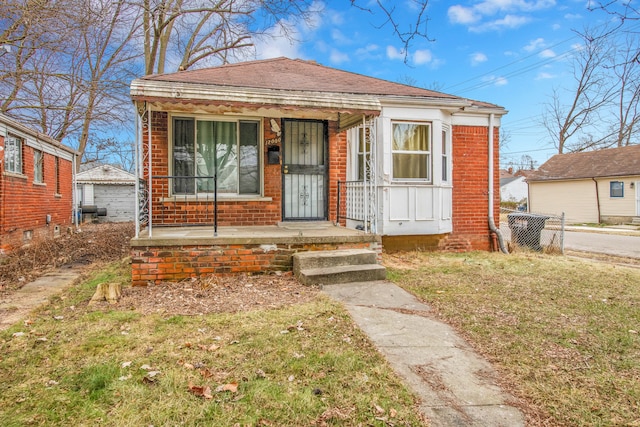 bungalow-style home with a front yard