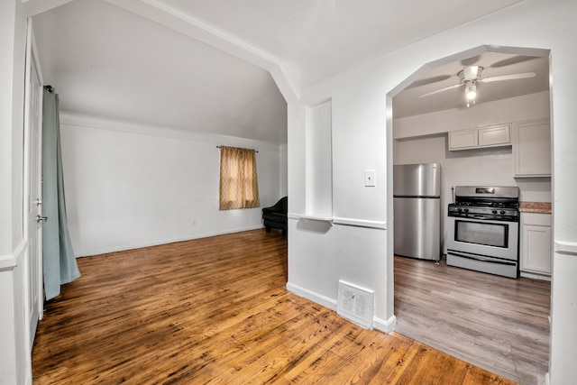 kitchen with ceiling fan, hardwood / wood-style flooring, and appliances with stainless steel finishes