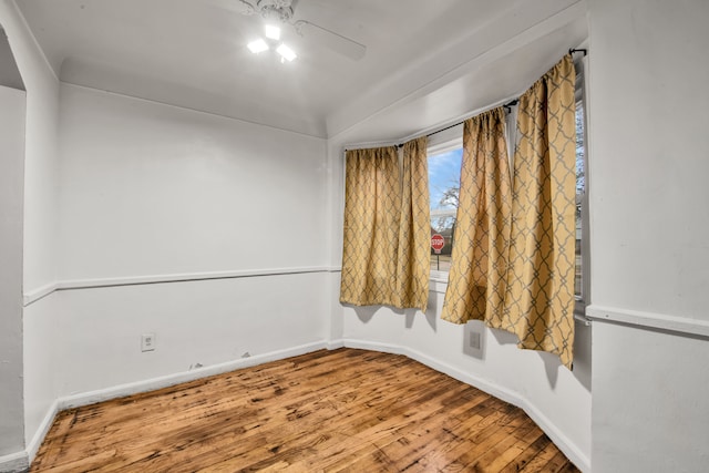 empty room with hardwood / wood-style floors and ceiling fan