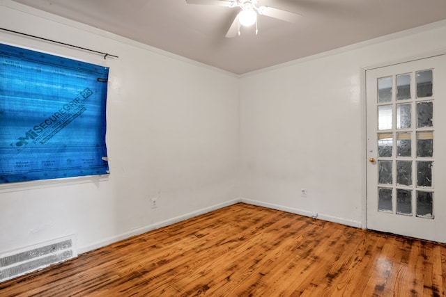 spare room with hardwood / wood-style flooring, ceiling fan, and ornamental molding