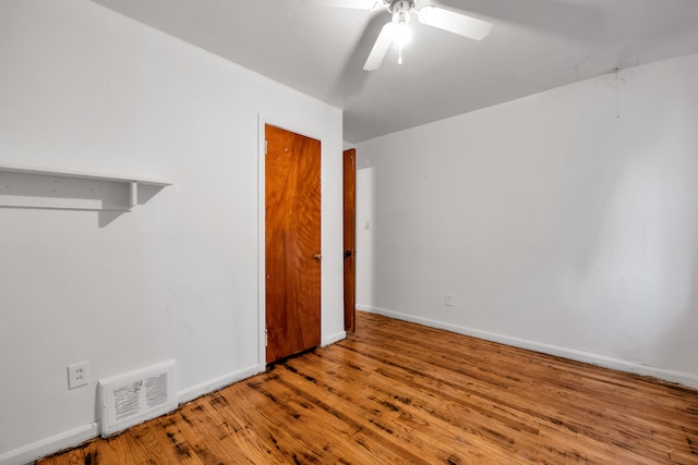 empty room featuring hardwood / wood-style floors and ceiling fan