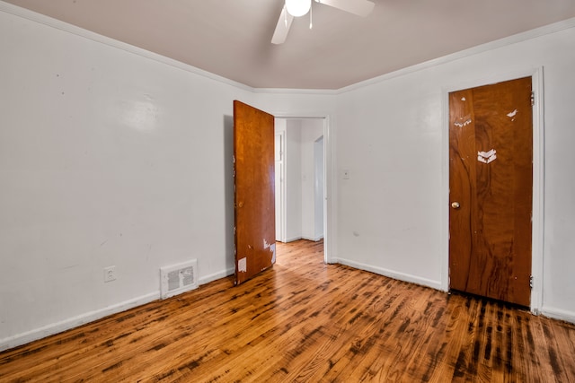 spare room featuring ceiling fan, crown molding, and hardwood / wood-style flooring