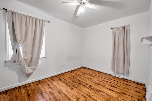 spare room with hardwood / wood-style flooring and ceiling fan