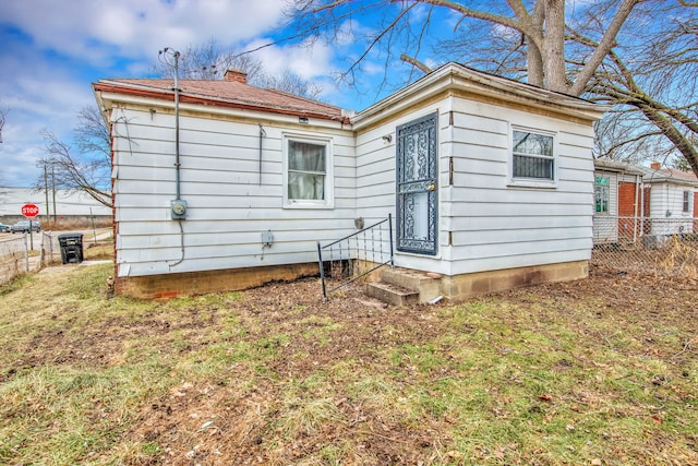 rear view of property with a yard