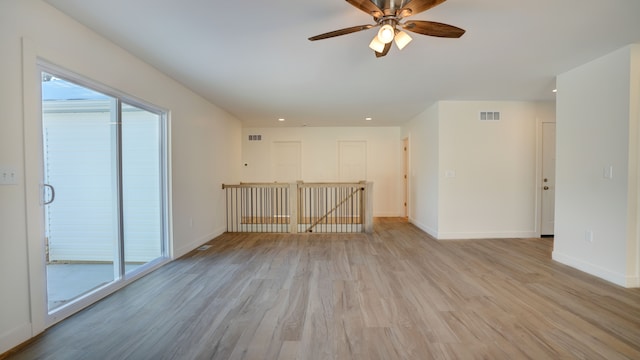 empty room with light hardwood / wood-style floors, ceiling fan, and a healthy amount of sunlight