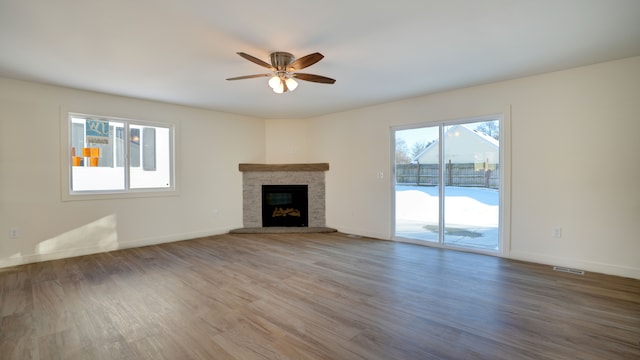 unfurnished living room with wood-type flooring and ceiling fan