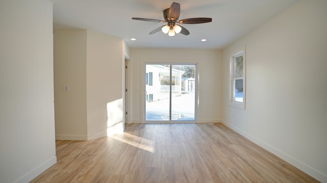 empty room featuring ceiling fan and light wood-type flooring