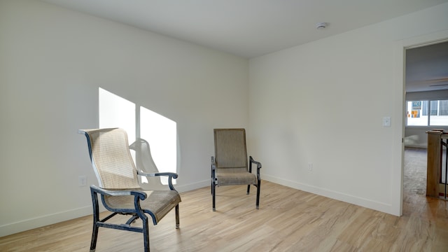 sitting room featuring ceiling fan and light hardwood / wood-style floors