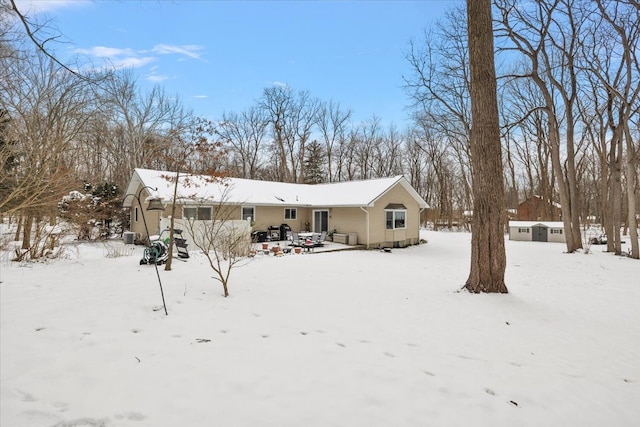 view of snow covered rear of property