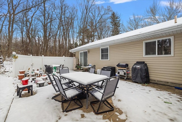 snow covered patio featuring grilling area