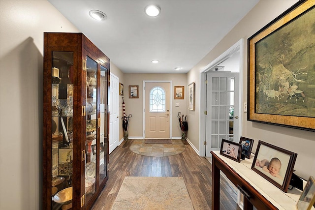 entrance foyer featuring dark hardwood / wood-style floors and french doors