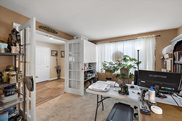 home office with light carpet and french doors