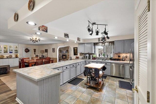 5400 Grange Hall Rd, Holly, MI 48442 - kitchen featuring recessed lighting, gray cabinets, stainless steel dishwasher, decorative backsplash, and a peninsula