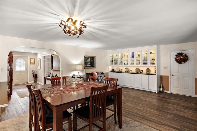 5400 Grange Hall Rd, Holly, MI 48442 - dining area with arched walkways, dark wood-style flooring, and baseboards