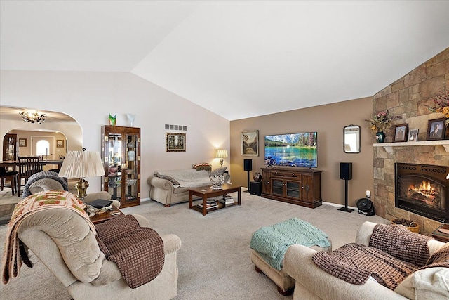 5400 Grange Hall Rd, Holly, MI 48442 - living area with arched walkways, vaulted ceiling, light colored carpet, and a stone fireplace