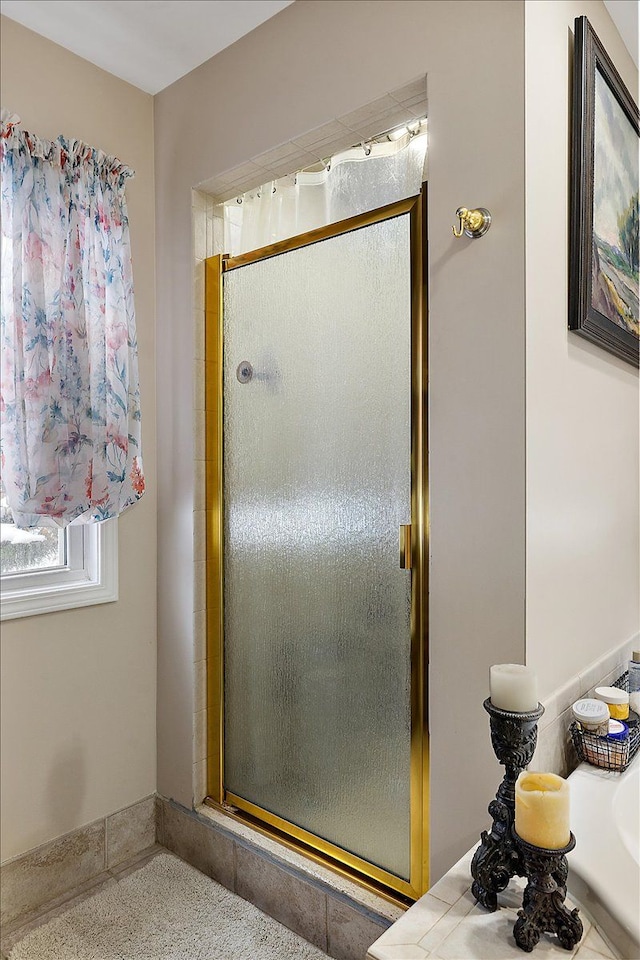 bathroom featuring a shower with shower door