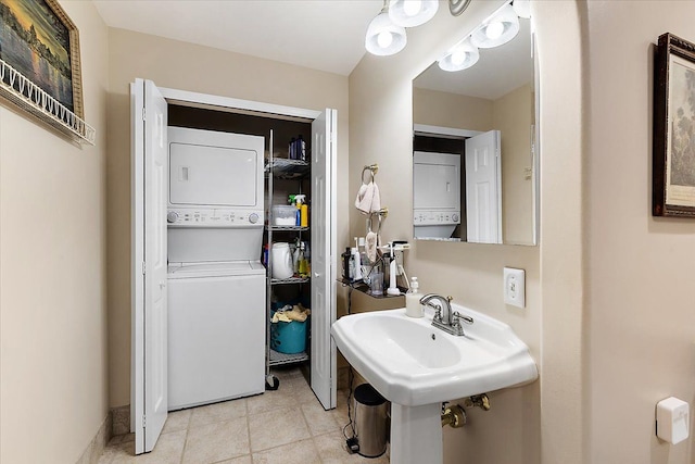 bathroom featuring sink and stacked washer and clothes dryer